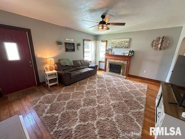 611 13th St, De Witt, IA 52742 - living area with a ceiling fan, hardwood / wood-style flooring, and a tiled fireplace