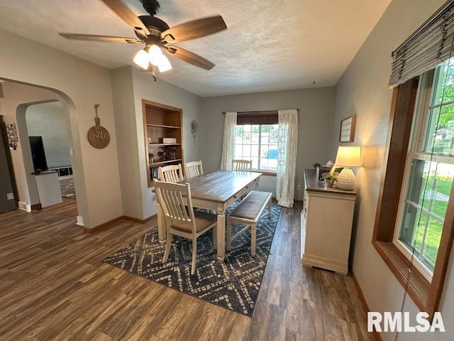 611 13th St, De Witt, IA 52742 - dining space featuring arched walkways, wood finished floors, ceiling fan, and a textured ceiling