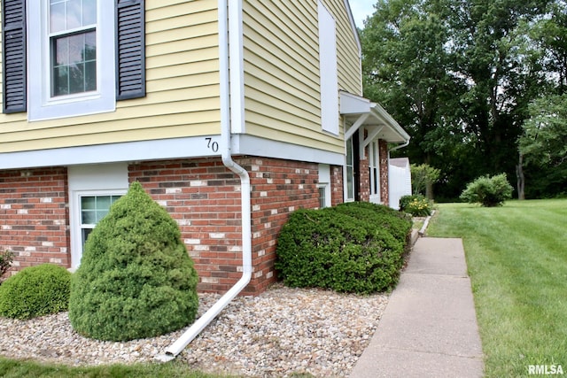 70 Carriage Hl, Macomb, IL 61455 - view of home's exterior featuring a lawn and brick siding