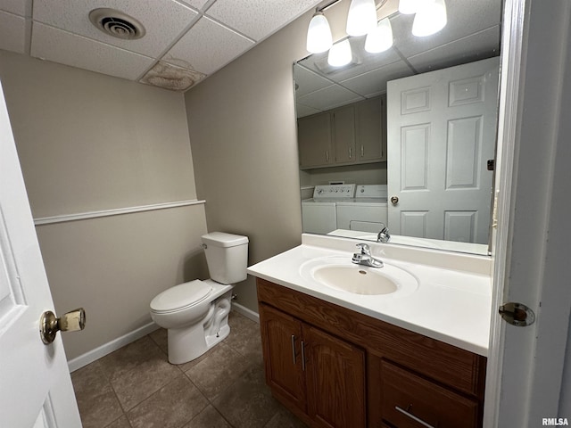 70 Carriage Hl, Macomb, IL 61455 - bathroom with washer and dryer, a drop ceiling, vanity, and tile patterned floors