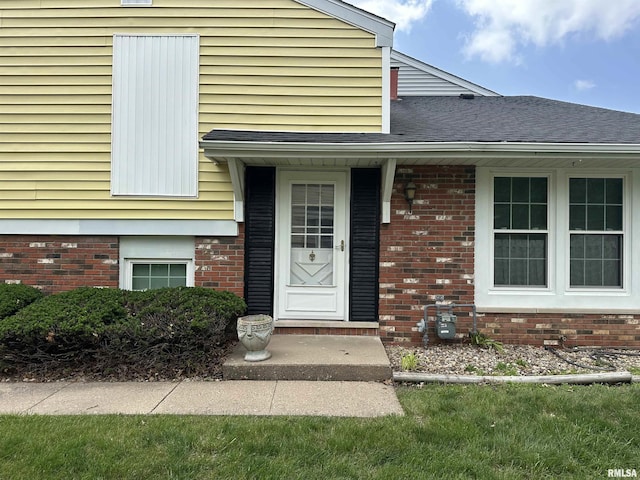 70 Carriage Hl, Macomb, IL 61455 - property entrance with roof with shingles and brick siding
