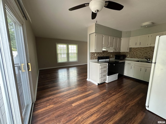 70 Carriage Hl, Macomb, IL 61455 - kitchen featuring black appliances, under cabinet range hood, tasteful backsplash, and dark wood-style flooring