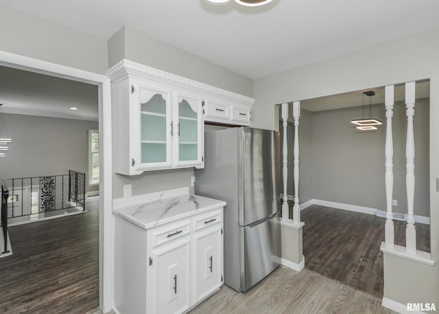 3503 36th St, Moline, IL 61265 - kitchen featuring wood finished floors, freestanding refrigerator, white cabinetry, glass insert cabinets, and light stone counters