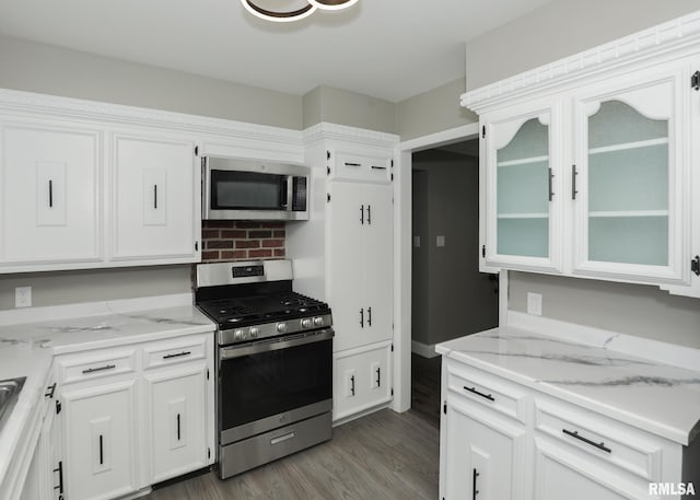 3503 36th St, Moline, IL 61265 - kitchen with appliances with stainless steel finishes, white cabinetry, wood finished floors, and light stone countertops
