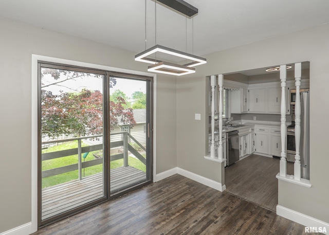 3503 36th St, Moline, IL 61265 - unfurnished dining area with dark wood finished floors and baseboards