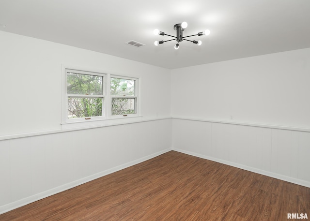3503 36th St, Moline, IL 61265 - unfurnished room featuring wood finished floors, a chandelier, and a wainscoted wall