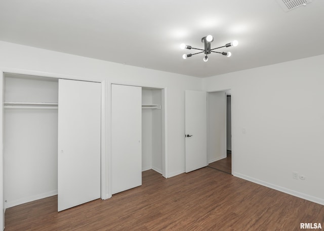 3503 36th St, Moline, IL 61265 - unfurnished bedroom featuring two closets, wood finished floors, and a chandelier