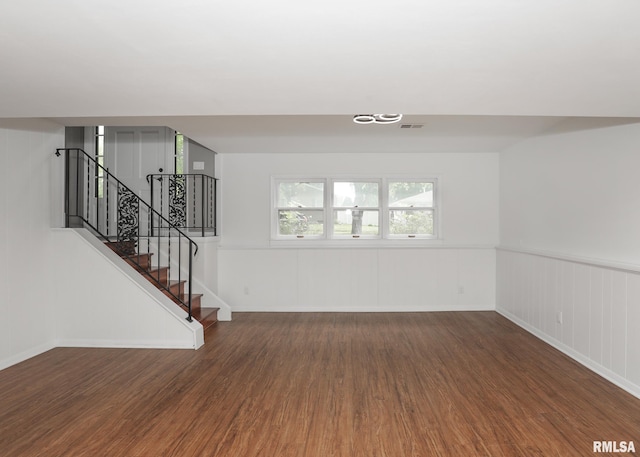 3503 36th St, Moline, IL 61265 - unfurnished living room with wood finished floors, stairs, and a wainscoted wall