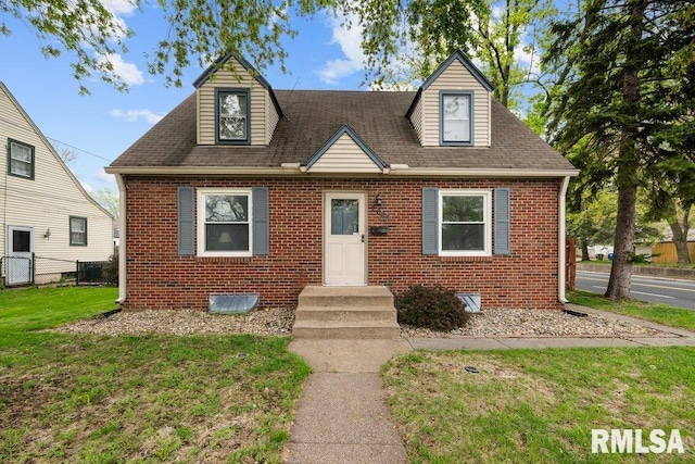 2605 Pacific St, Davenport, IA 52804 - view of front of home with brick siding, a front lawn, and a shingled roof