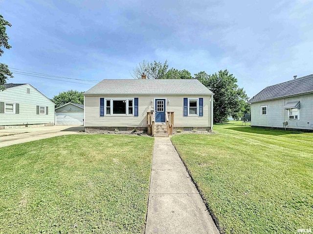 409 E Pearl St, Geneseo, IL 61254 - view of front of house with a front yard, a garage, a chimney, and an outdoor structure