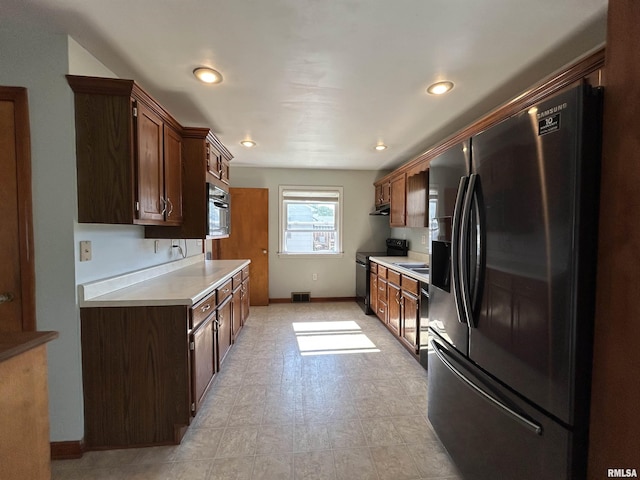 409 E Pearl St, Geneseo, IL 61254 - kitchen featuring refrigerator with ice dispenser, black range with electric cooktop, light countertops, dark brown cabinetry, and recessed lighting
