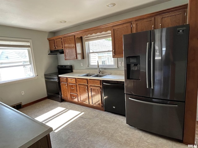 409 E Pearl St, Geneseo, IL 61254 - kitchen featuring black appliances, under cabinet range hood, healthy amount of natural light, light countertops, and recessed lighting