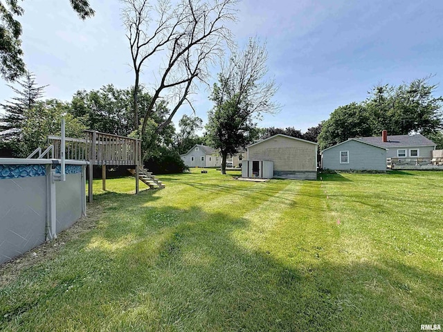 409 E Pearl St, Geneseo, IL 61254 - view of grassy yard with a deck and stairway