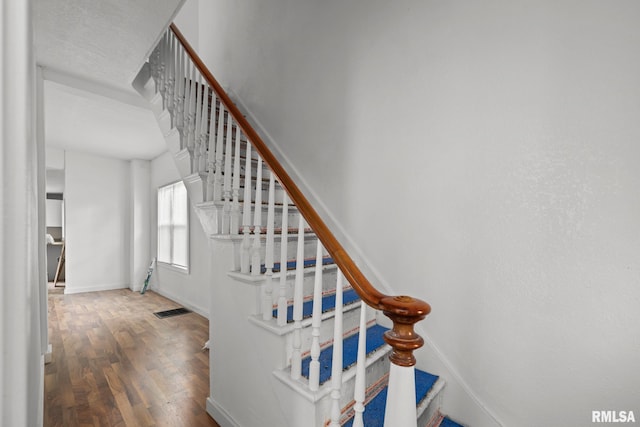 1312 Farnam St, Davenport, IA 52803 - stairs featuring wood finished floors and baseboards