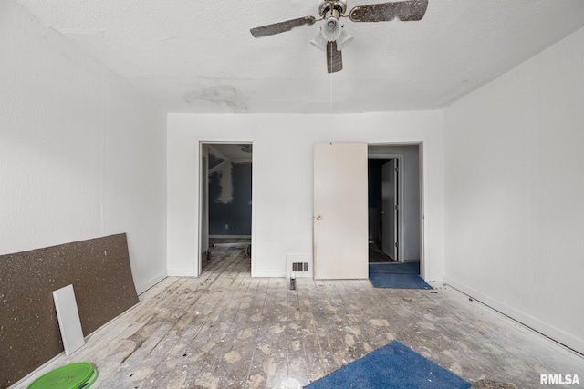 1312 Farnam St, Davenport, IA 52803 - empty room featuring ceiling fan and a textured ceiling