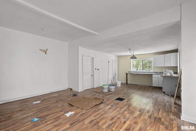 1312 Farnam St, Davenport, IA 52803 - unfurnished living room with wood finished floors and baseboards