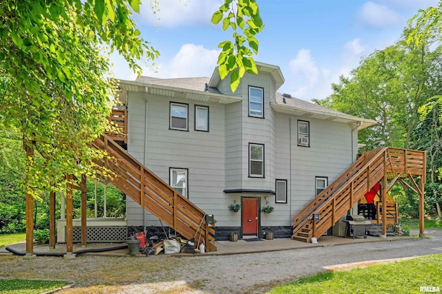 1520 10th Ave, Moline, IL 61265 - back of property with stairs, a shingled roof, and a patio area