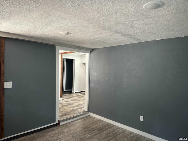 1415 45th Ave, Rock Island, IL 61201 - spare room with wood finished floors and a textured ceiling