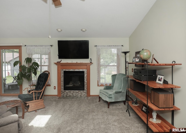 2035 N Gayman Ave, Davenport, IA 52804 - living area with carpet floors, healthy amount of natural light, lofted ceiling, a fireplace with flush hearth, and a ceiling fan