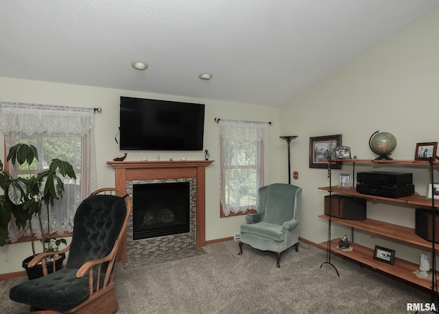 2035 N Gayman Ave, Davenport, IA 52804 - carpeted living room with healthy amount of natural light, a tiled fireplace, and vaulted ceiling