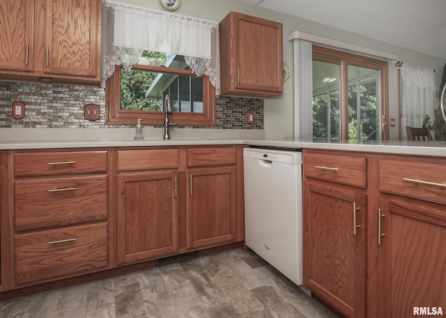 2035 N Gayman Ave, Davenport, IA 52804 - kitchen with white dishwasher, decorative backsplash, and healthy amount of natural light