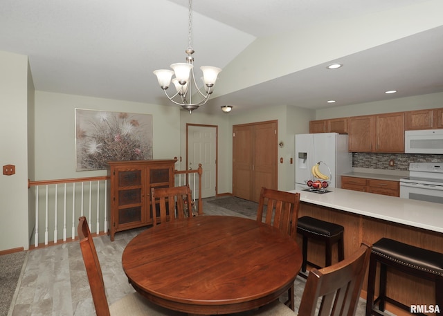 2035 N Gayman Ave, Davenport, IA 52804 - dining area with lofted ceiling, a chandelier, and light wood-style flooring