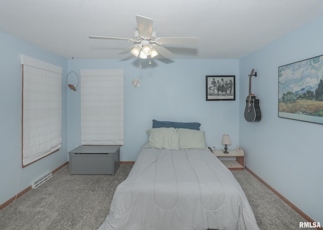 2035 N Gayman Ave, Davenport, IA 52804 - carpeted bedroom with baseboards and a ceiling fan