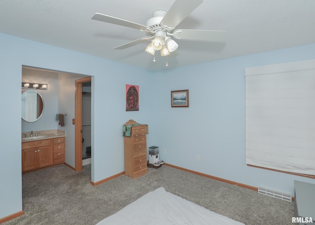 2035 N Gayman Ave, Davenport, IA 52804 - carpeted bedroom featuring ensuite bath and ceiling fan