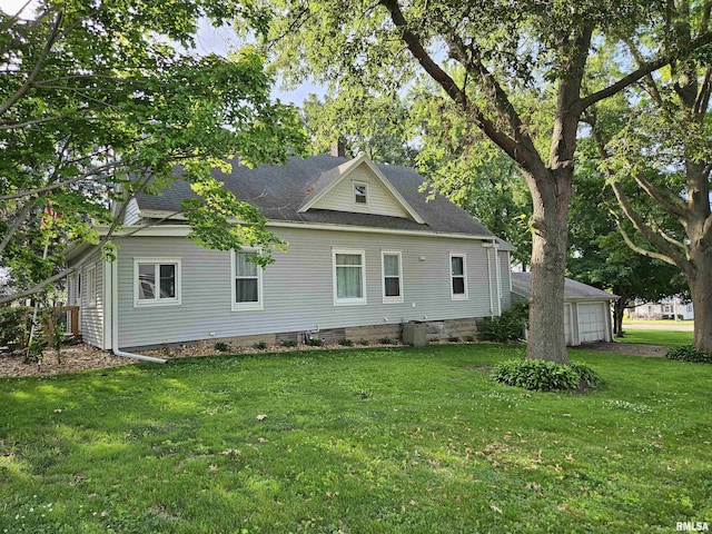 320 W 4th St, Wilton, IA 52778 - back of house featuring a yard, roof with shingles, and a chimney