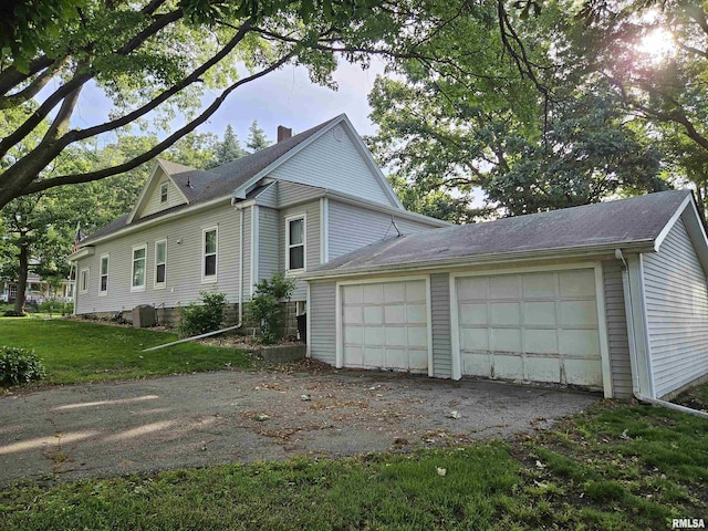 320 W 4th St, Wilton, IA 52778 - view of side of home with a chimney, an outdoor structure, and an attached garage