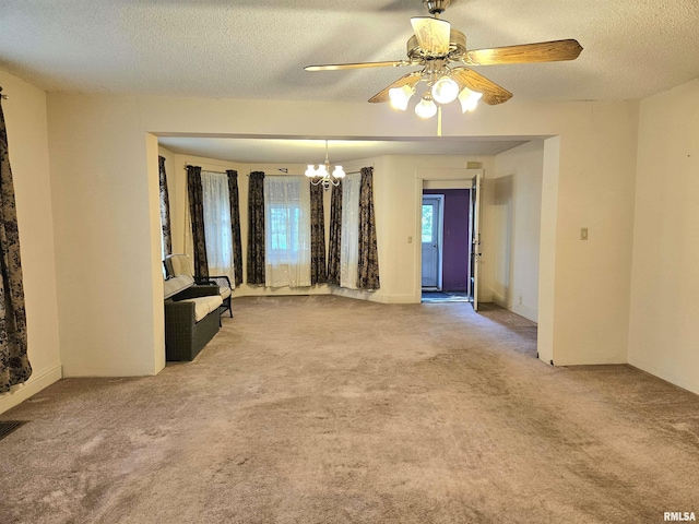 320 W 4th St, Wilton, IA 52778 - carpeted spare room featuring a chandelier, a textured ceiling, and ceiling fan