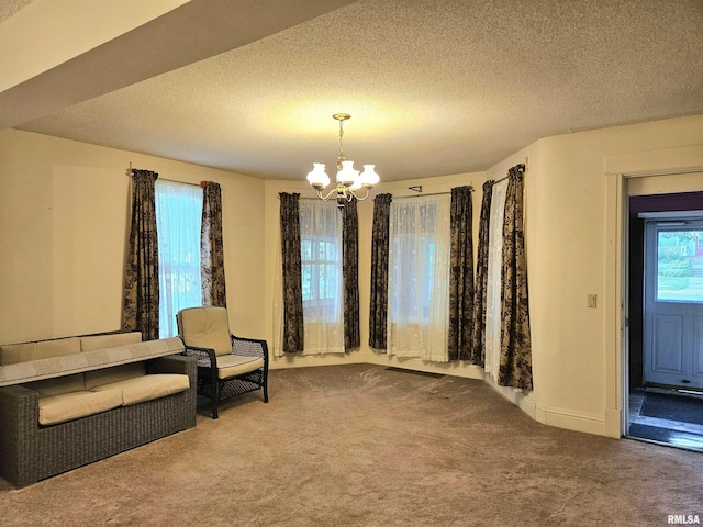 320 W 4th St, Wilton, IA 52778 - unfurnished room with carpet, a chandelier, and a textured ceiling