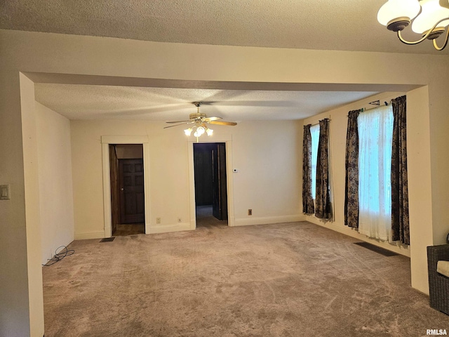 320 W 4th St, Wilton, IA 52778 - carpeted empty room featuring a chandelier, a ceiling fan, and a textured ceiling