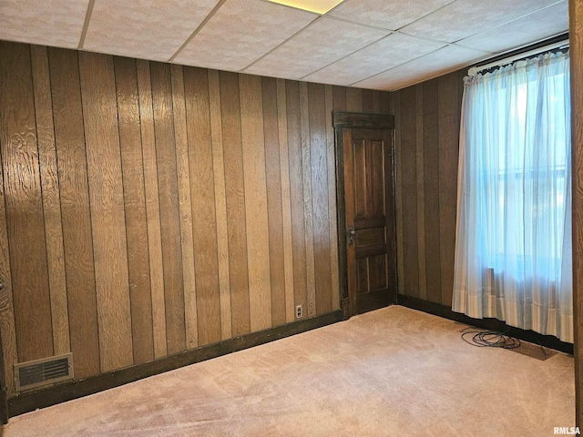 320 W 4th St, Wilton, IA 52778 - empty room with carpet, wood walls, and a paneled ceiling