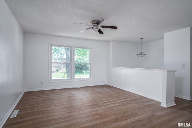 1811 Valley Dr, Davenport, IA 52806 - spare room with a textured ceiling, wood finished floors, a chandelier, and ceiling fan