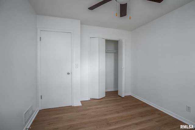 1811 Valley Dr, Davenport, IA 52806 - unfurnished bedroom featuring wood finished floors, a closet, and a ceiling fan