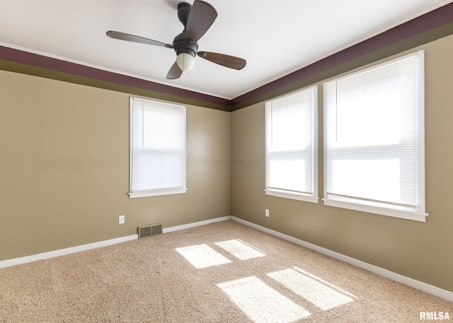 1035 14th Ave S, Clinton, IA 52732 - carpeted empty room with baseboards and ceiling fan