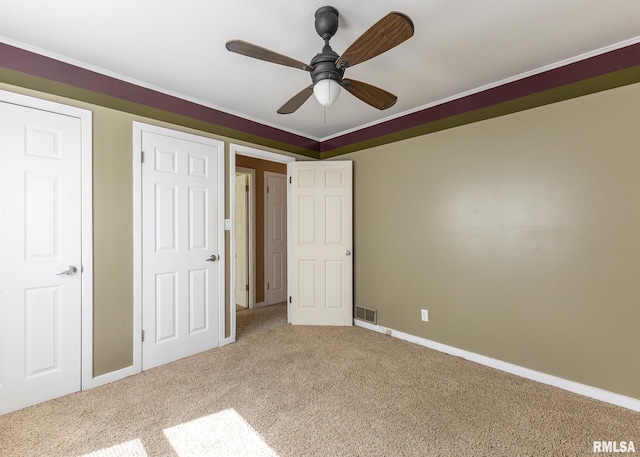 1035 14th Ave S, Clinton, IA 52732 - unfurnished bedroom featuring carpet and ceiling fan