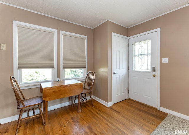 1035 14th Ave S, Clinton, IA 52732 - dining space featuring ornamental molding, wood finished floors, healthy amount of natural light, and a desk