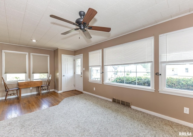 1035 14th Ave S, Clinton, IA 52732 - foyer entrance with ceiling fan, ornamental molding, recessed lighting, carpet, and wood finished floors