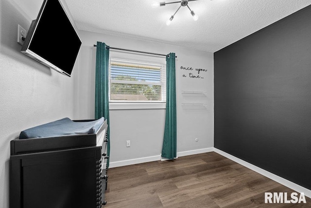 3307 Clover Hills Dr, Bettendorf, IA 52722 - bedroom with a textured ceiling and wood finished floors