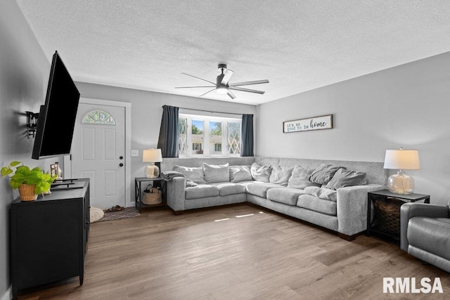 3307 Clover Hills Dr, Bettendorf, IA 52722 - living area featuring ceiling fan, healthy amount of natural light, wood finished floors, and a textured ceiling
