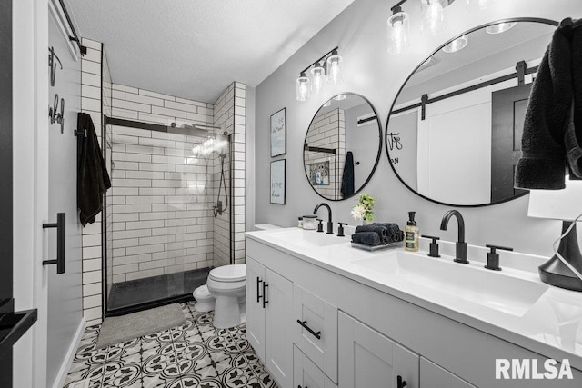3307 Clover Hills Dr, Bettendorf, IA 52722 - bathroom with a stall shower, double vanity, a textured ceiling, and tile patterned flooring
