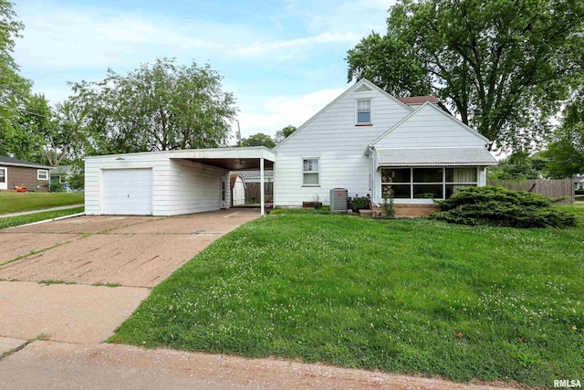 2348 24 1/2 St, Rock Island, IL 61201 - view of front of property with an outbuilding, concrete driveway, and a sunroom