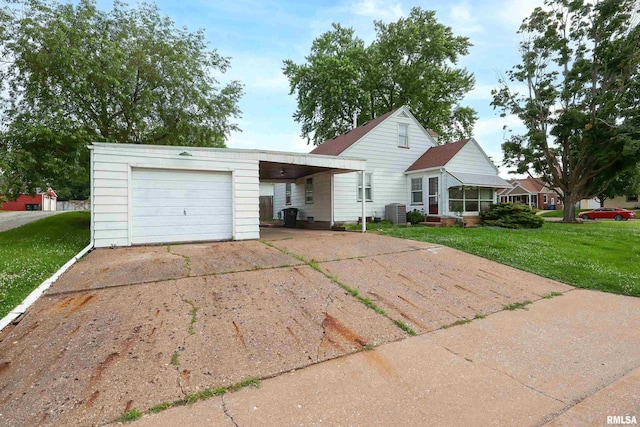 2348 24 1/2 St, Rock Island, IL 61201 - view of front of house featuring a front yard, concrete driveway, and a carport