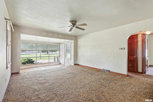 2348 24 1/2 St, Rock Island, IL 61201 - spare room featuring carpet, ceiling fan, and arched walkways