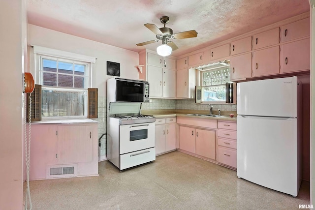 2348 24 1/2 St, Rock Island, IL 61201 - kitchen featuring white appliances, light countertops, decorative backsplash, and a ceiling fan