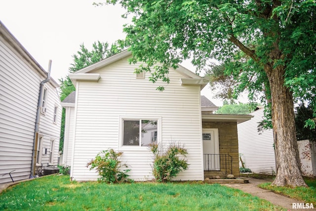 535 Adams St, Quincy, IL 62301 - view of front of house with stone siding, a front yard, and a shingled roof