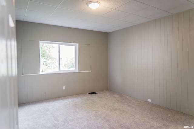 535 Adams St, Quincy, IL 62301 - empty room with carpet floors, wood walls, and a drop ceiling