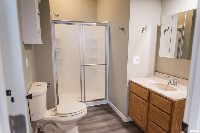 535 Adams St, Quincy, IL 62301 - bathroom featuring vanity, a shower stall, and wood finished floors